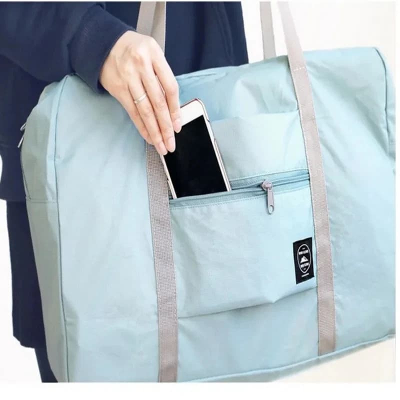 The duffel bag in Dark Blue showing the suitcase pass-through sleeve