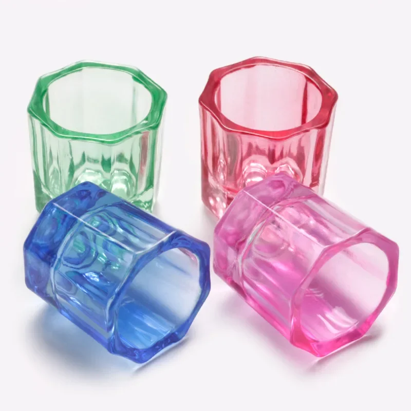 Multiple dappen dishes in clear, green, red, and blue glass
