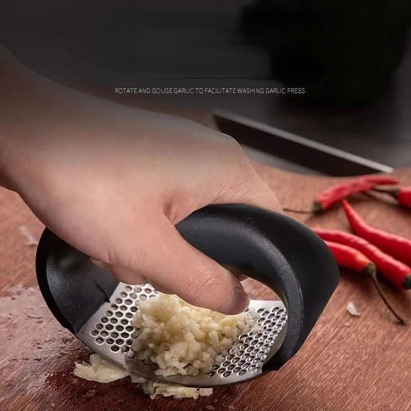 Close-up of stainless steel garlic press showing the press mechanism
