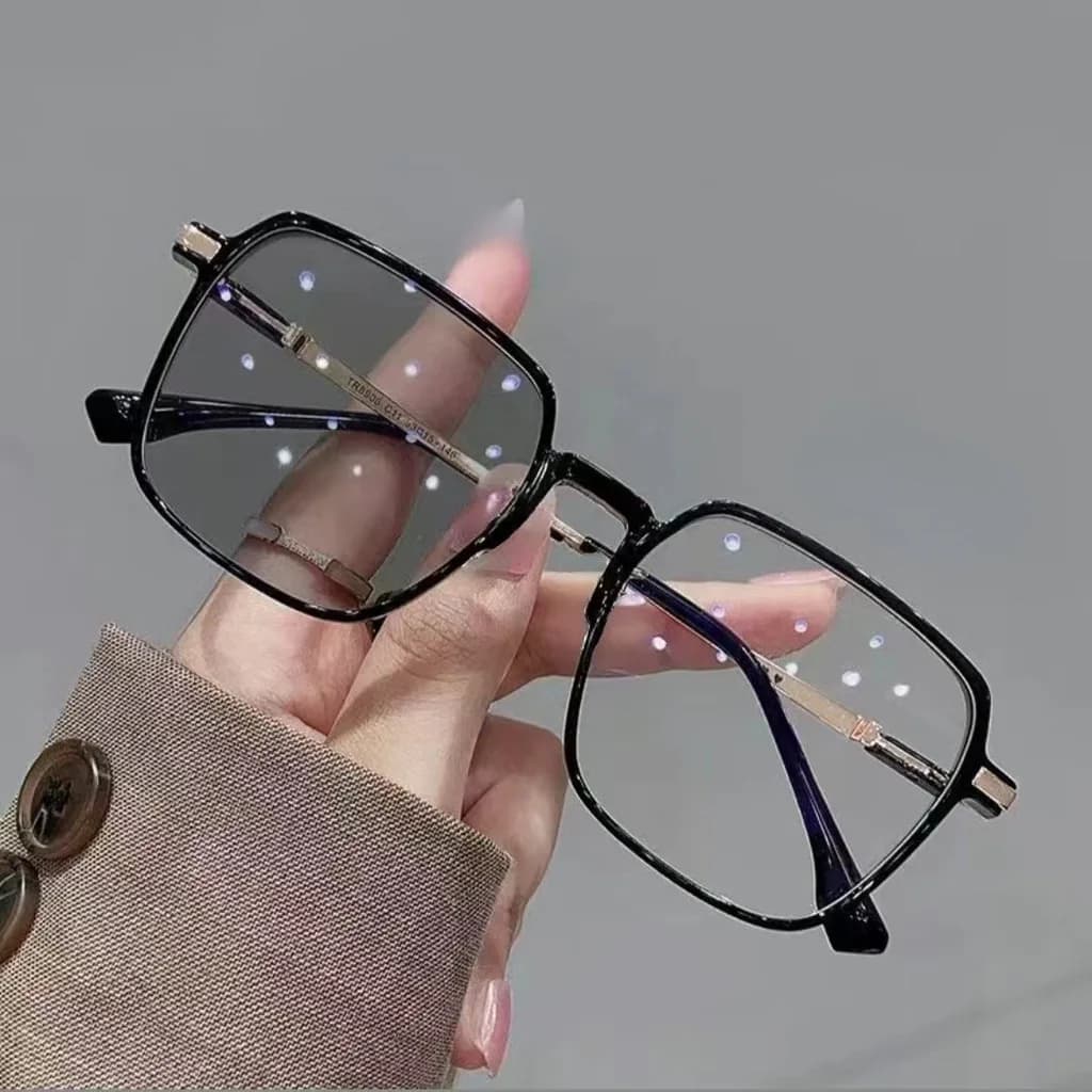 Side view of photochromic glasses showing metal frame and lens tint