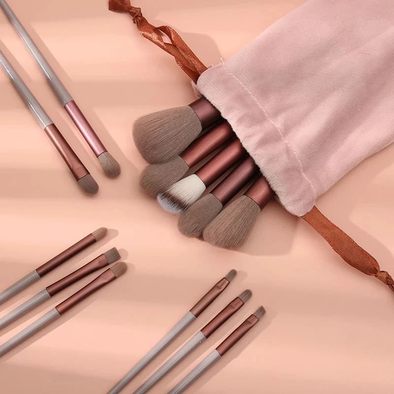 Fan brush displayed next to other makeup brushes for size comparison